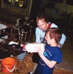 Roz with grandson feeding cow by Harry LItman